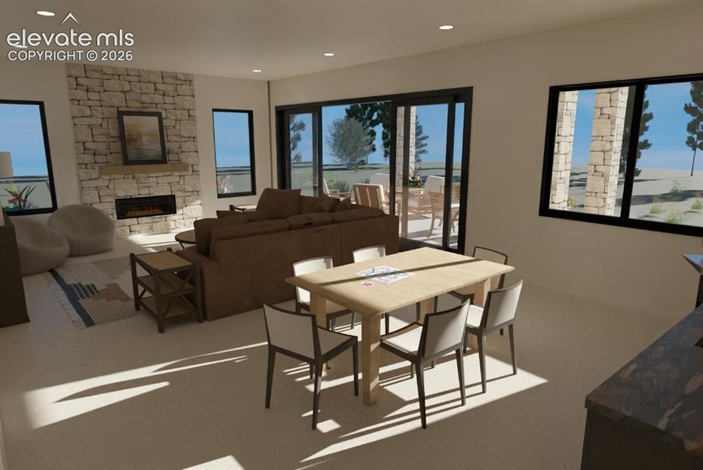 Image 18 of 32: Open-concept family room featuring a stacked stone fireplace with an integr