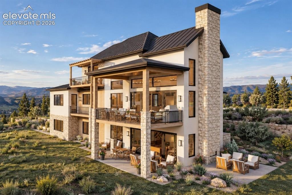 Image 2 of 32: Multi-level residence featuring a stone and stucco exterior, multiple patio