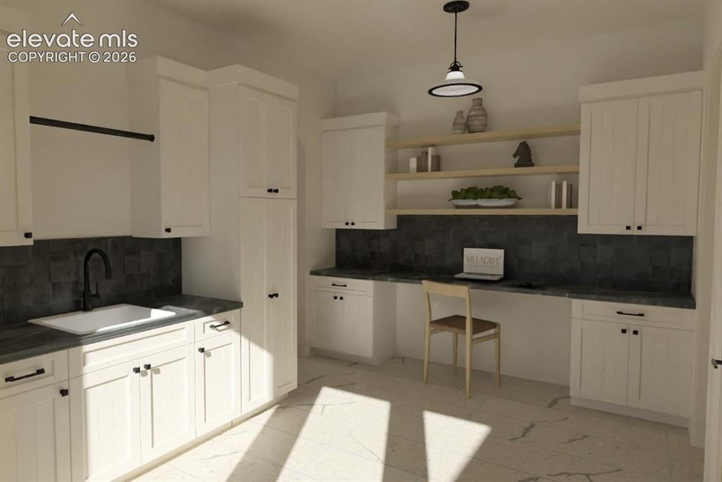 Image 20 of 32: White cabinetry with black hardware, integrated sink with a matte black fau