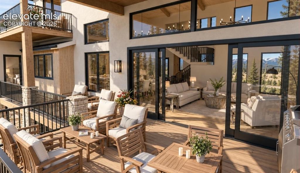 Image 7 of 32: Expansive outdoor deck with a lower-level balcony, stone pillar accents, an