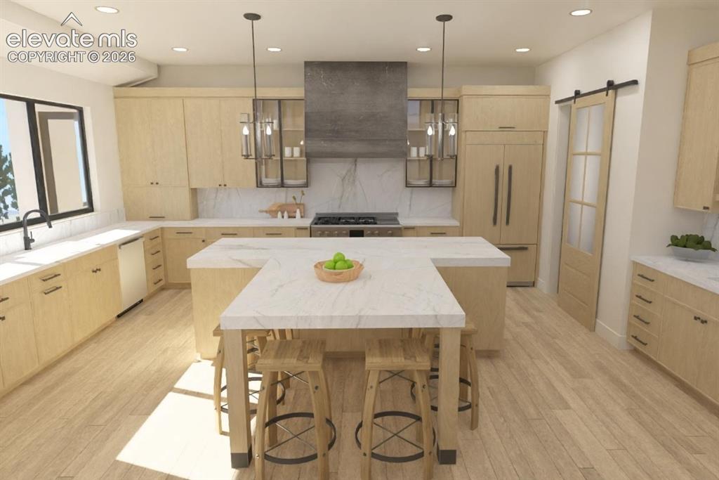 Image 8 of 32: Gourmet kitchen featuring custom wood cabinetry, a large center island with