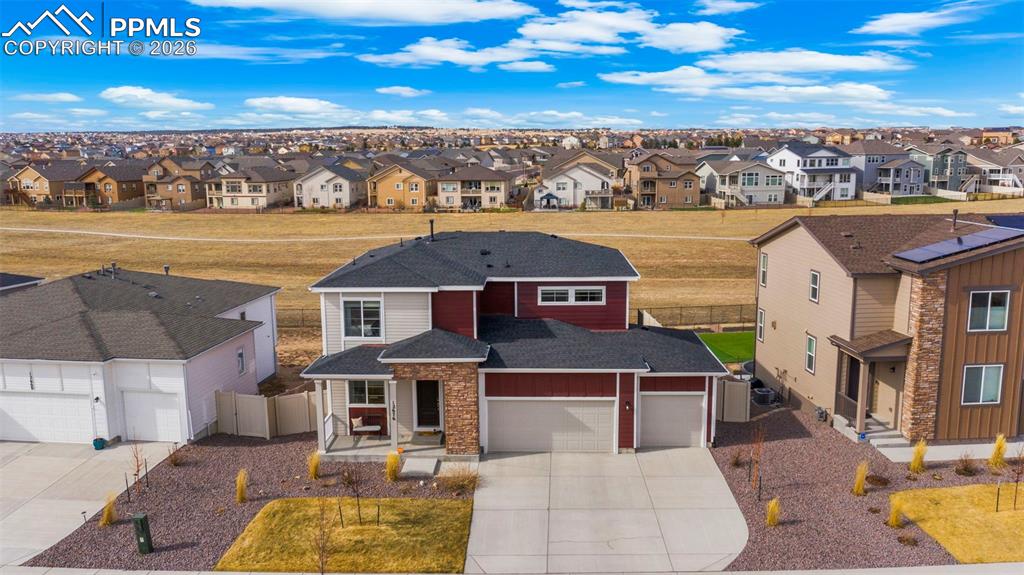 Image 12 of 43: Traditional-style house featuring concrete driveway, roof with shingles, a