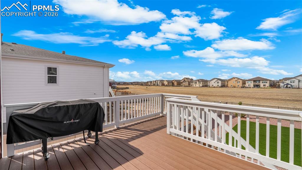 Image 14 of 43: Wooden terrace featuring a residential view and grilling area