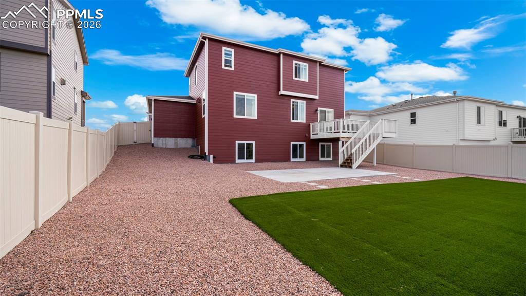 Image 17 of 43: Back of house featuring a fenced backyard, a patio area, and a wooden deck