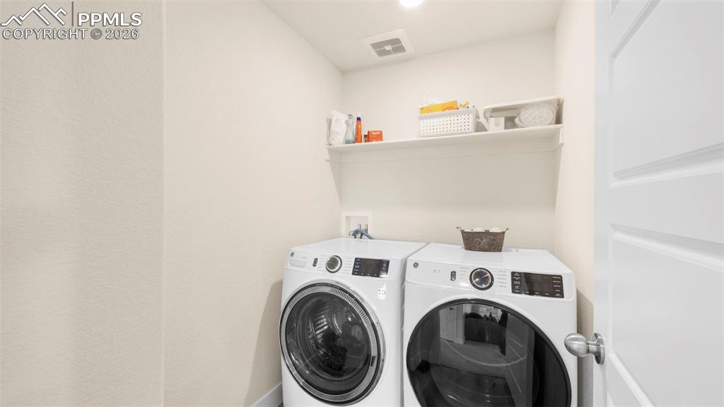 Image 20 of 43: Laundry area featuring washing machine and dryer