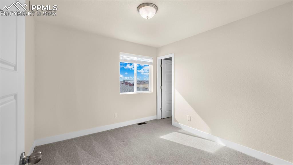 Image 21 of 43: Unfurnished bedroom featuring light colored carpet and baseboards