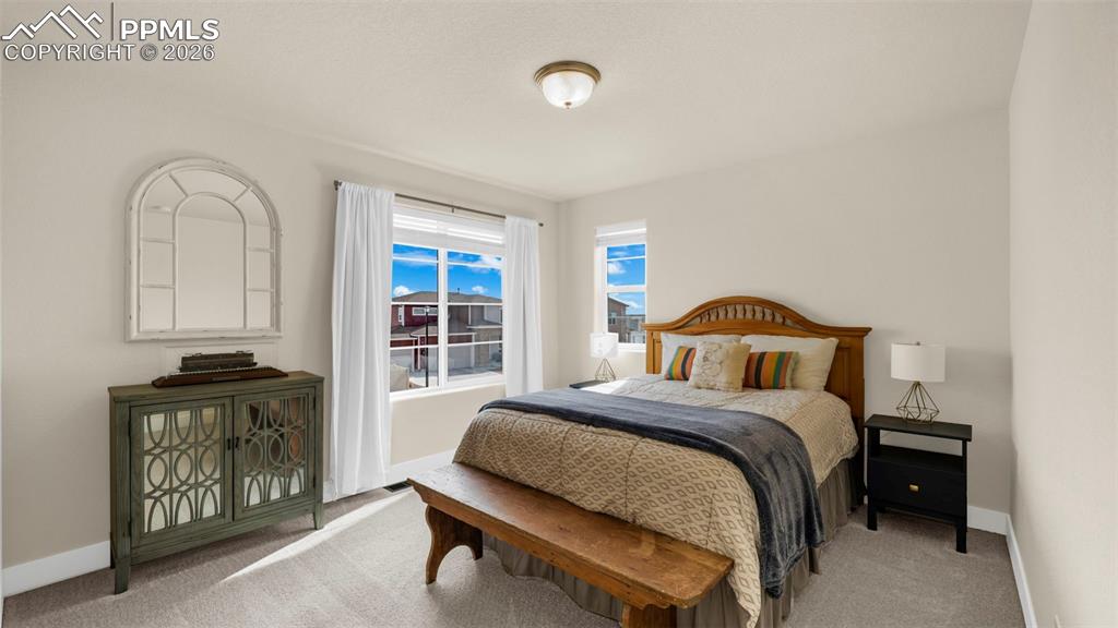 Image 23 of 43: Bedroom with baseboards and light carpet