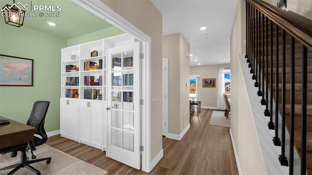 Image 38 of 43: Office area featuring wood finished floors and recessed lighting