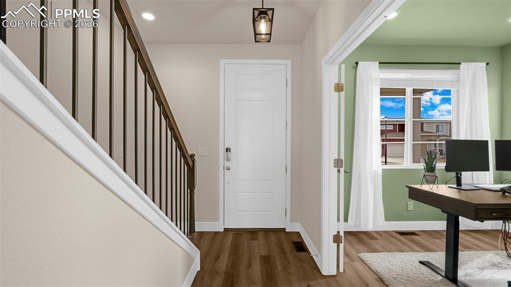 Image 39 of 43: Foyer with wood finished floors and recessed lighting