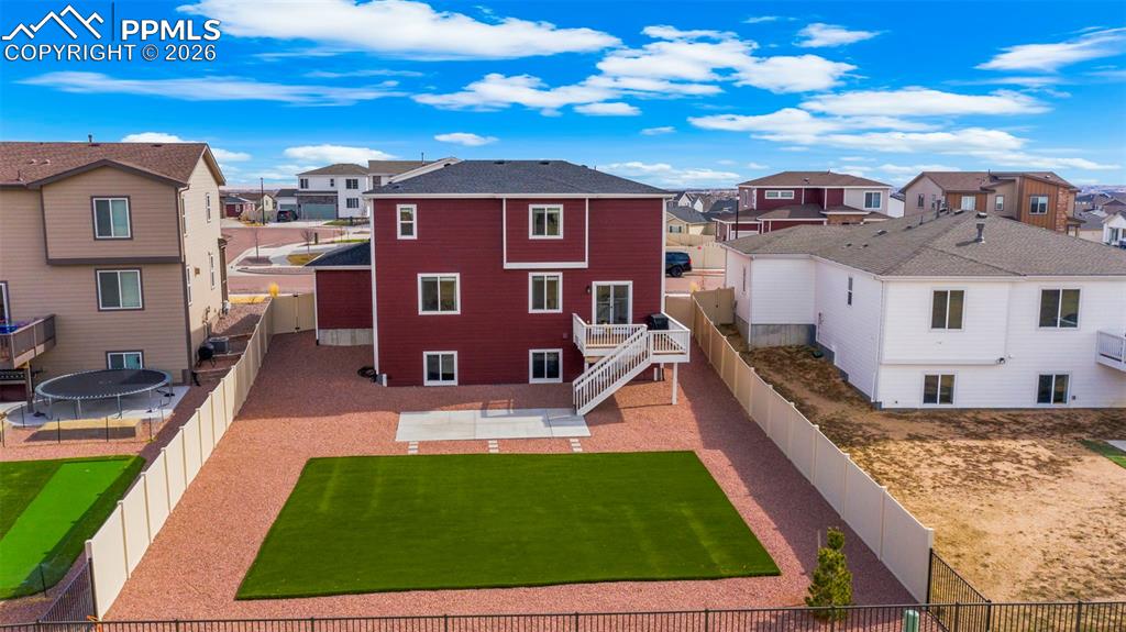 Image 7 of 43: Rear view of property with a residential view, a fenced backyard, and a pat