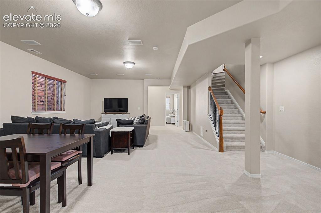 Image 23 of 39: Stairs down to finished basement