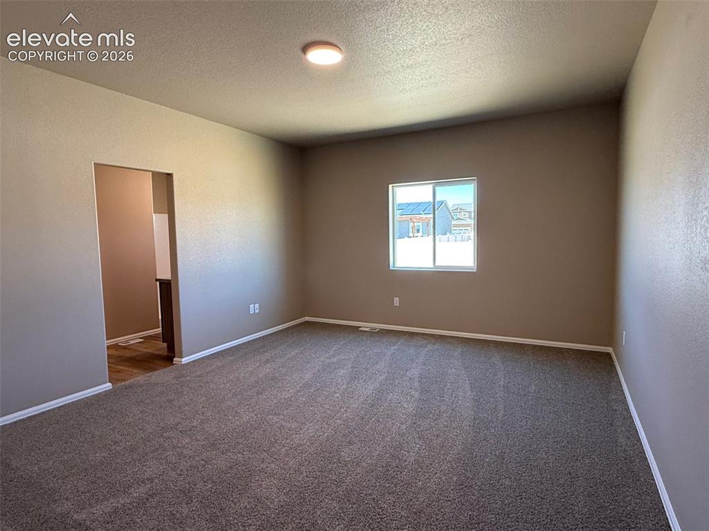 Image 13 of 34: Spacious room featuring carpeting, neutral wall tones, a recessed window, a