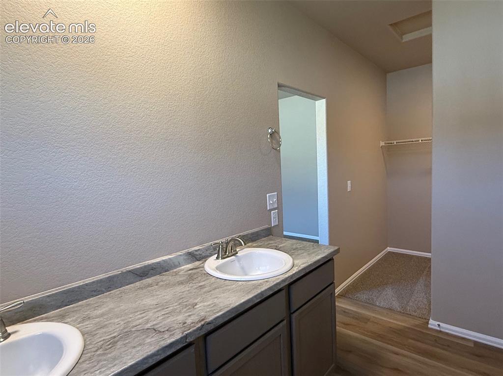 Image 18 of 34: Double vanity with light gray cabinetry and light-toned countertop
