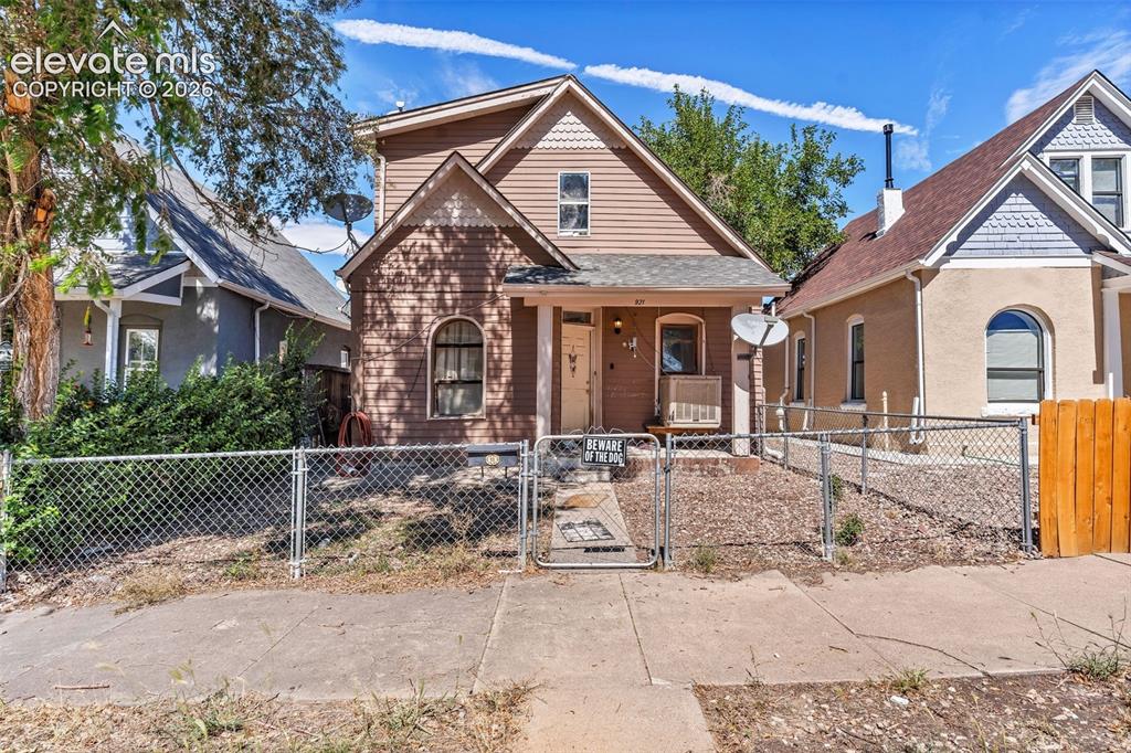 Image 2 of 4: Two-story residence featuring horizontal siding and a prominent gable roof