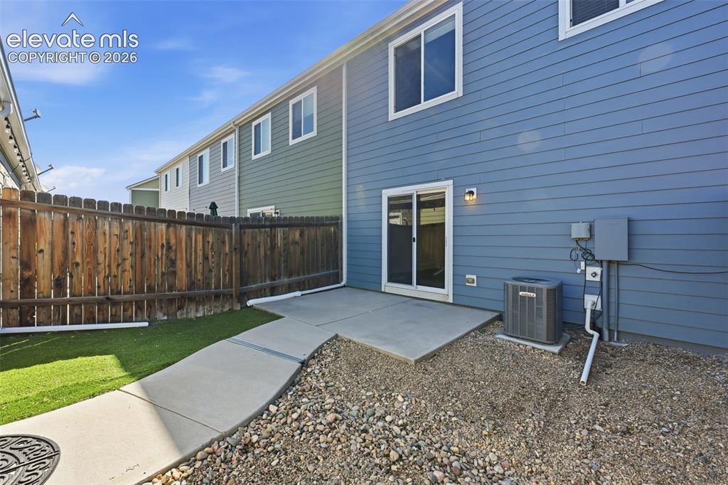 Image 30 of 37: private yard with turf and gravel
