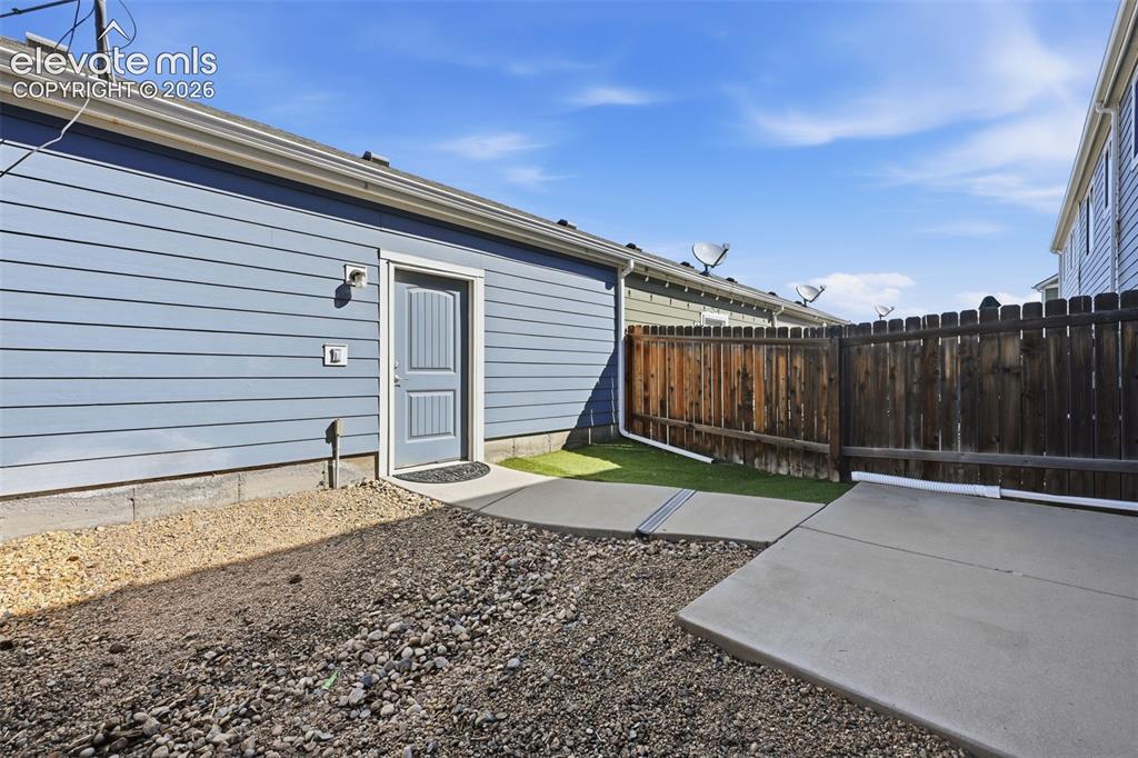 Image 31 of 37: private yard with garage entrance