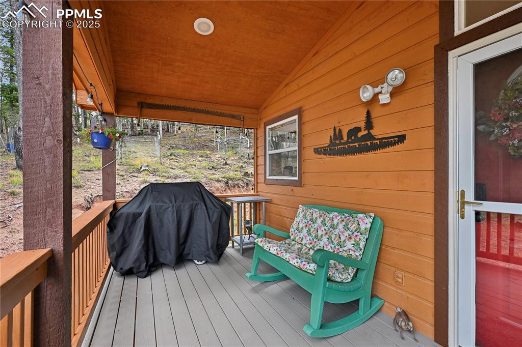 Image 2 of 34: Wooden terrace with area for grilling