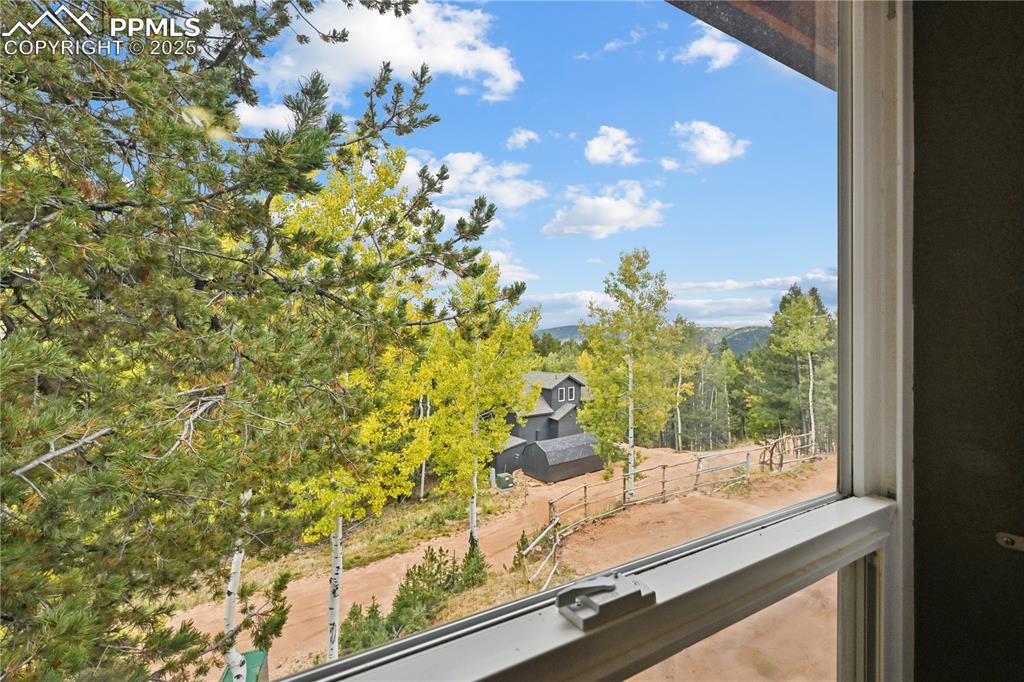 Image 32 of 34: Detailed view of a tree filled landscape and mountains