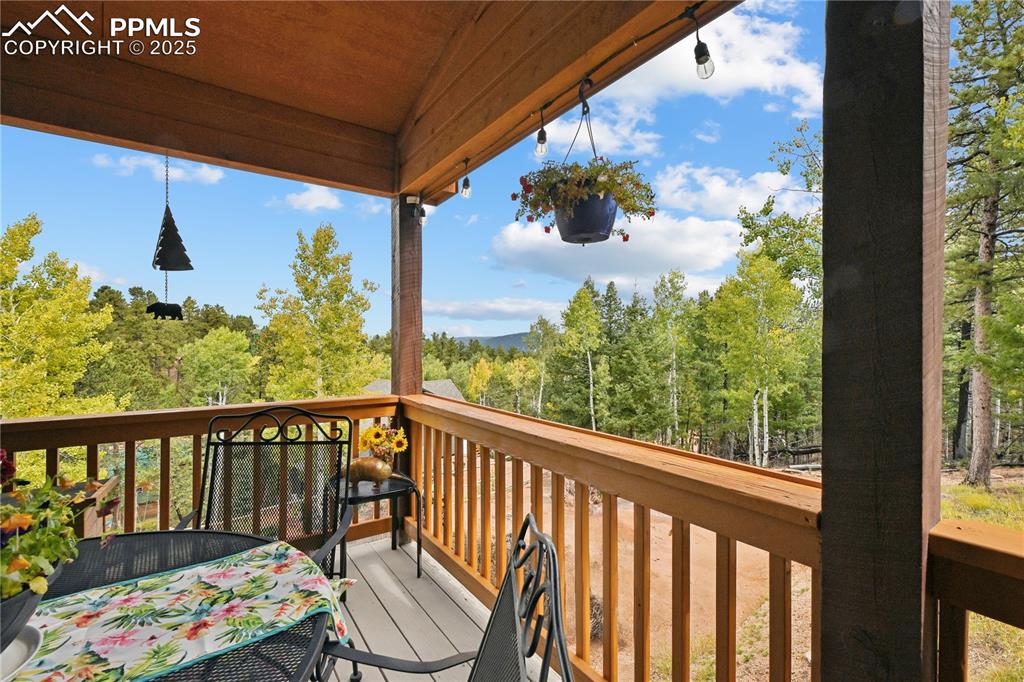 Image 4 of 34: Wooden deck with a wooded view