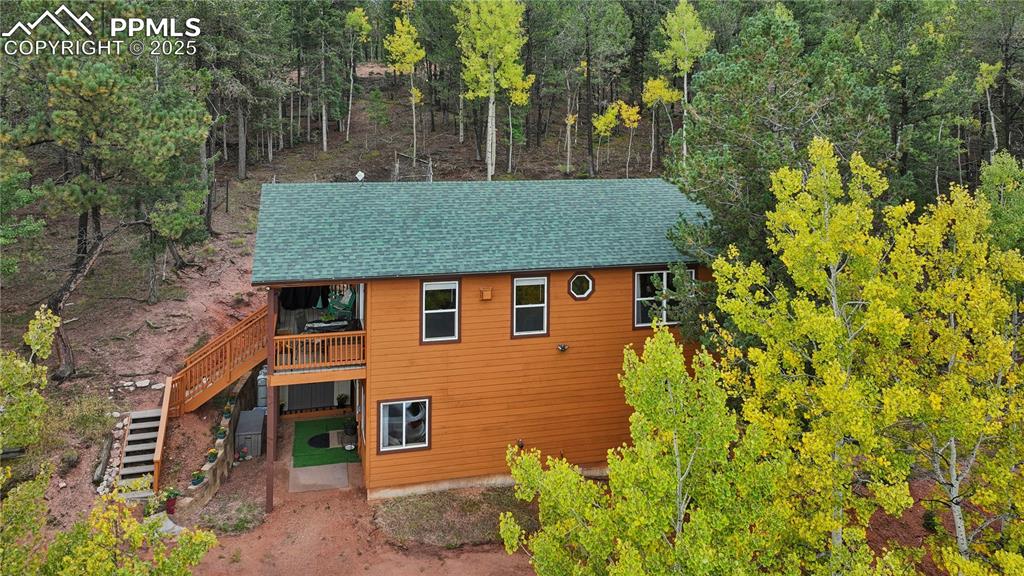 Image 5 of 34: View of front of house featuring stairway and a shingled roof