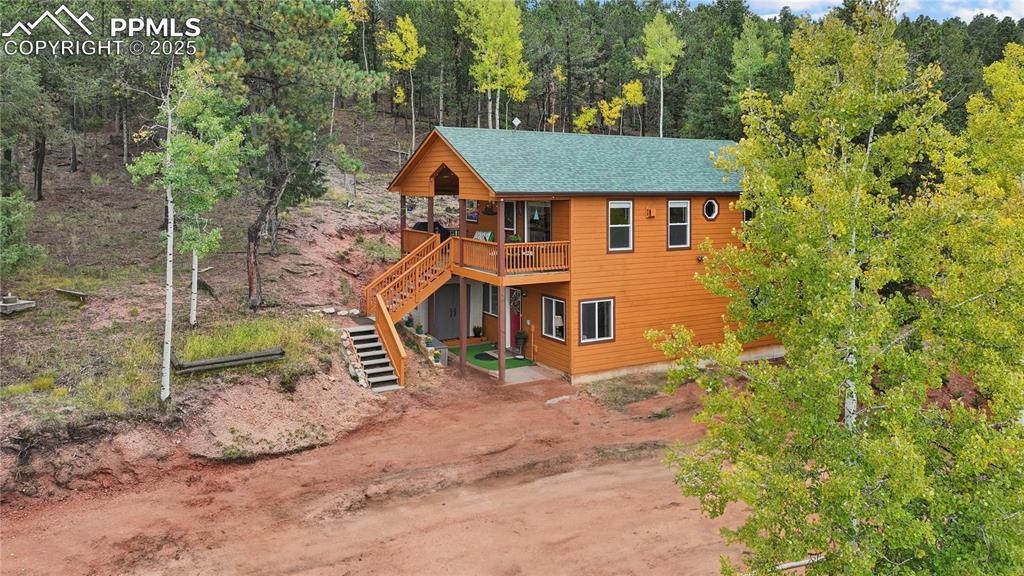 Image 7 of 34: View of front of house featuring stairway and a shingled roof