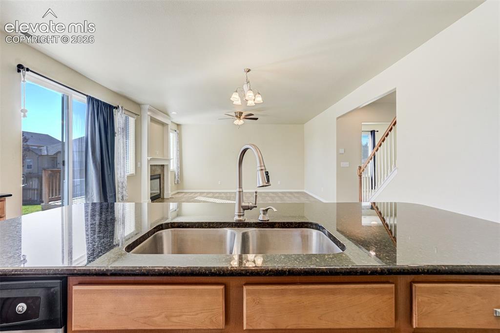 Image 19 of 49: Kitchen island featuring a double basin stainless steel sink with a goosene