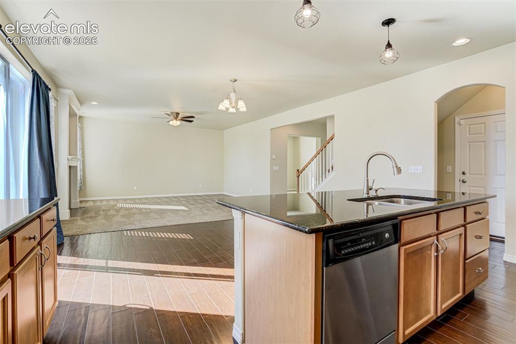 Image 20 of 49: Kitchen island with an undermount sink, gooseneck faucet, and integrated di