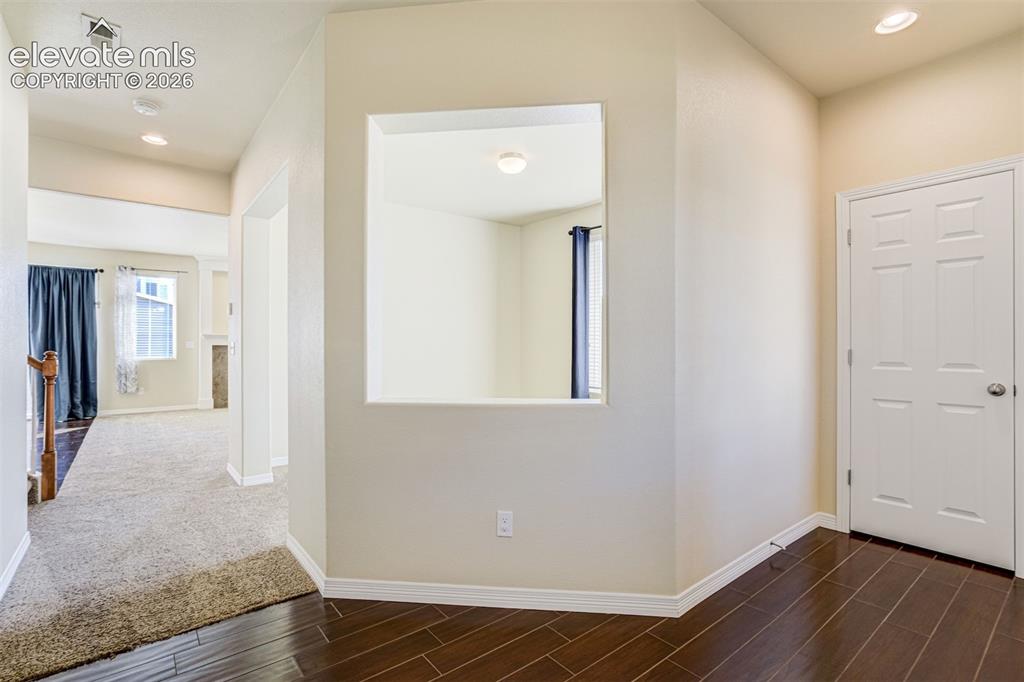 Image 6 of 49: Tiled flooring, interior wall cut-out, recessed lighting, and a paneled int