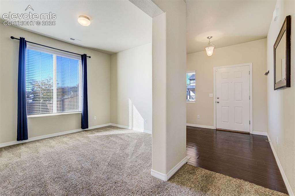 Image 7 of 49: Hardwood-finish flooring, recessed lighting, neutral wall tones, and a pane