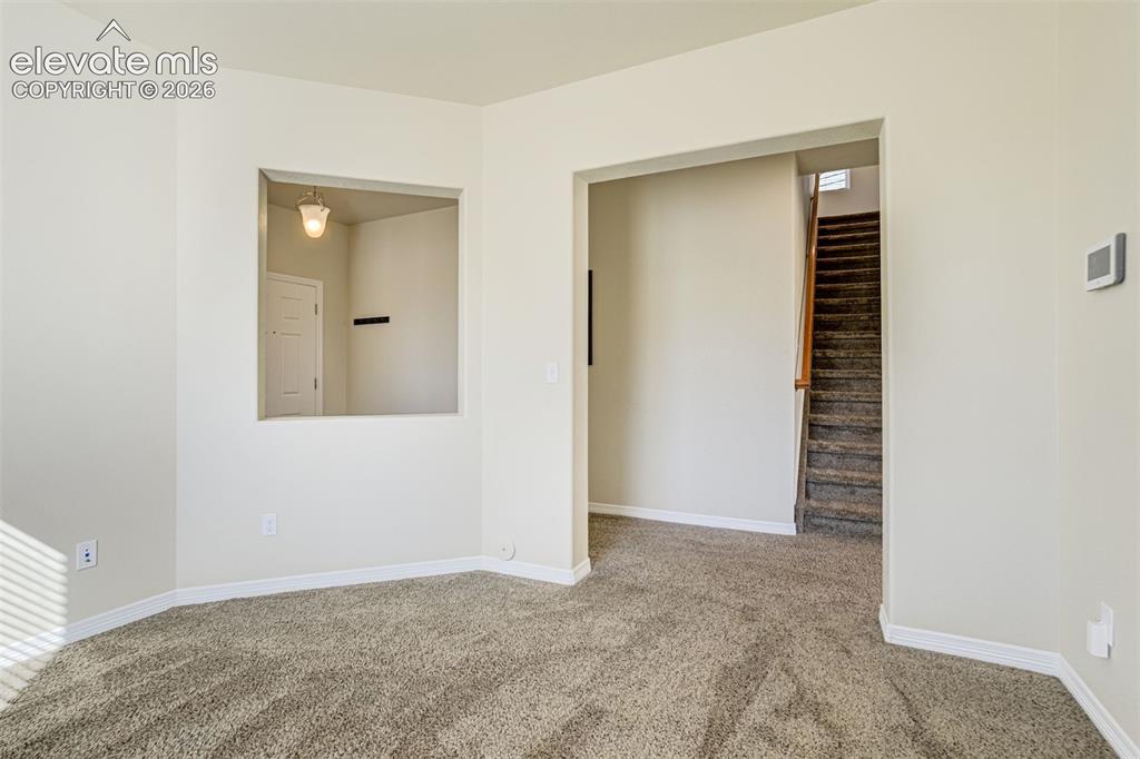 Image 9 of 49: Plush carpeting, neutral wall colors, and an open archway