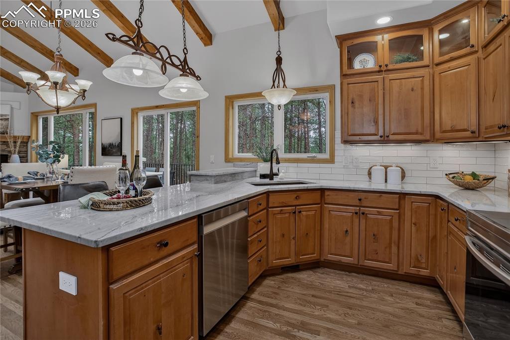 Image 17 of 48: GOURMET kitchen with beautifully stained Alder cabinets, subway tile backsp