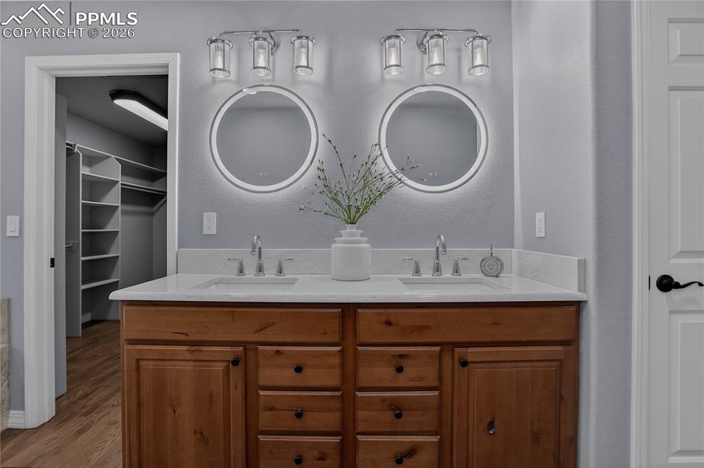 Image 25 of 48: Upgraded primary bath with modern finishes and access to the walk-in closet