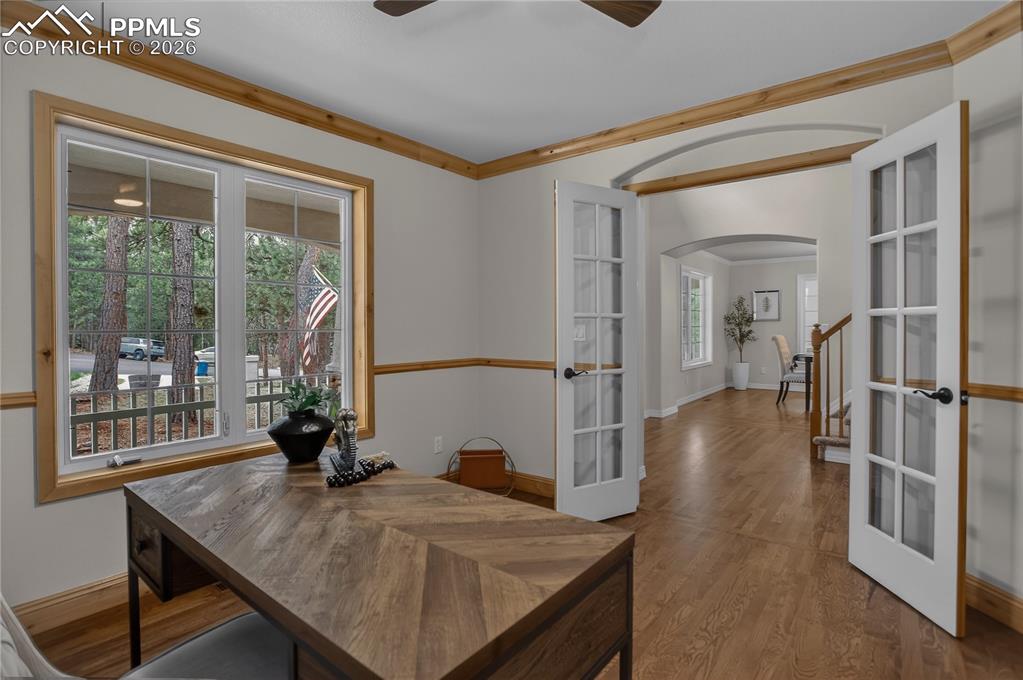 Image 26 of 48: Main-floor office near front entry with french doors, crown molding -- and 