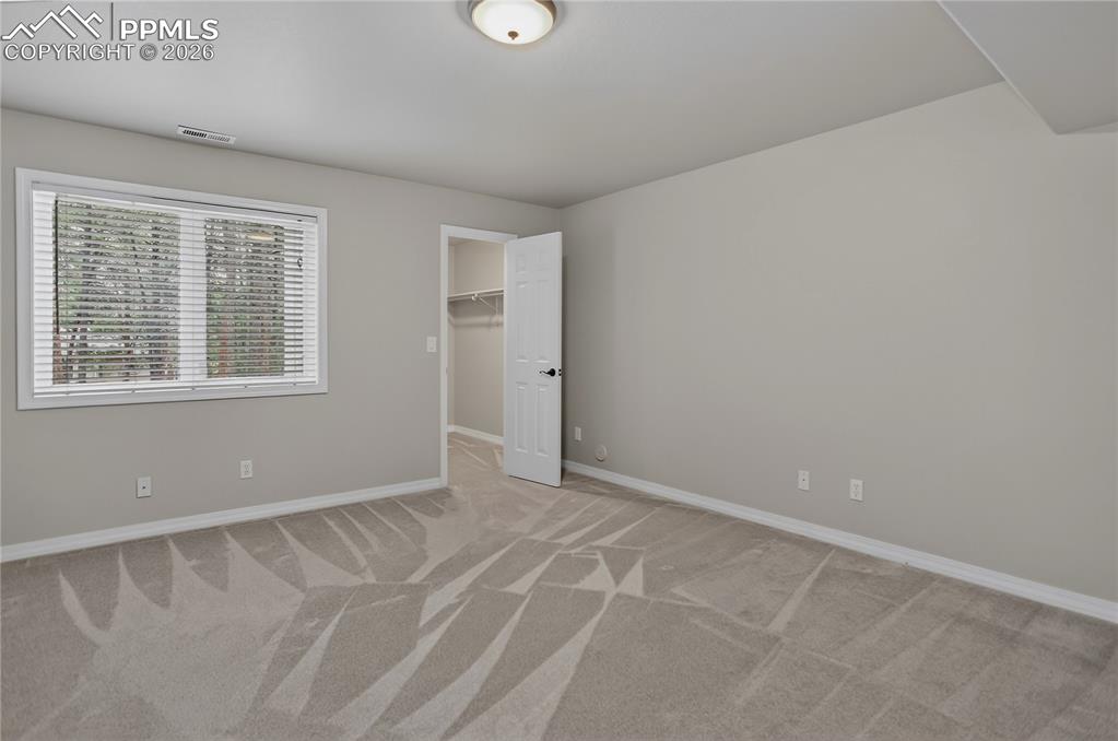 Image 35 of 48: Lower-level 4th bedroom has a walk-in closet