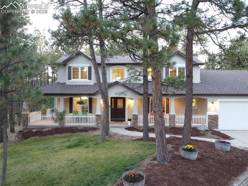 Image 43 of 48: Front of home is fully landscaped -- back is natural forest!