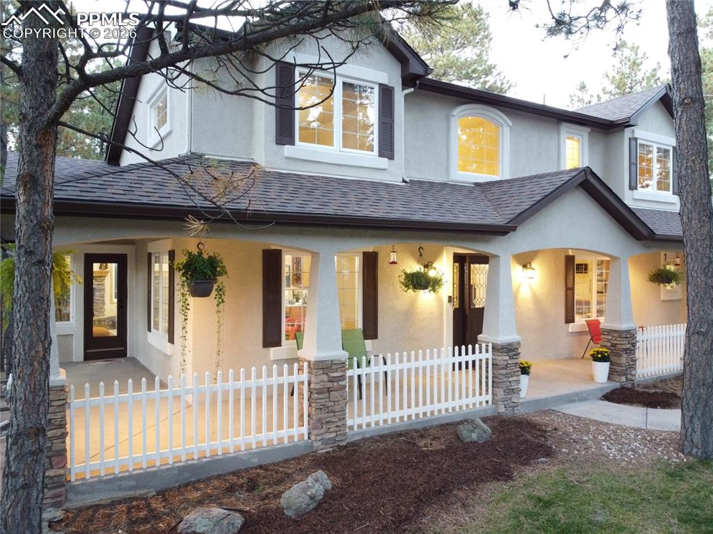 Image 44 of 48: Twilight photo of the welcoming front porch!