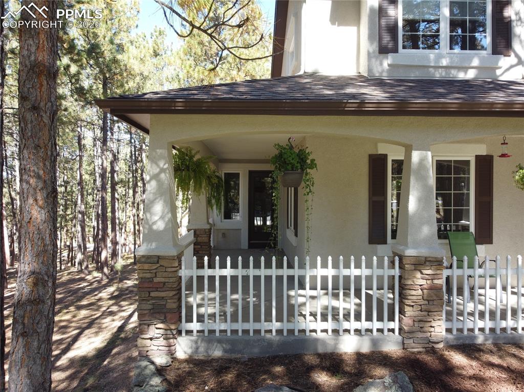 Image 5 of 48: Beautiful wrap-around porch has second entry into the Living Room
