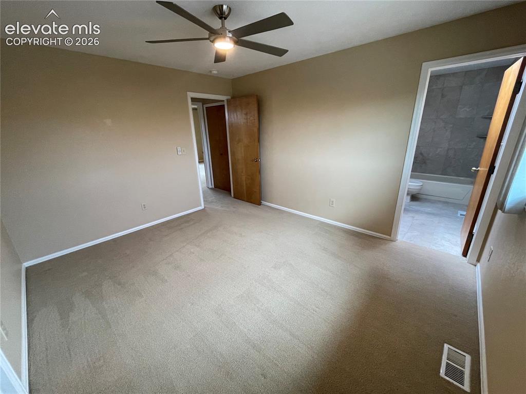 Image 18 of 25: 2nd bedroom showing door to bathroom