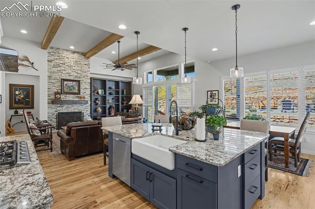 Image 13 of 50: An oversized contrasting island serves as the true heart of the home, offer