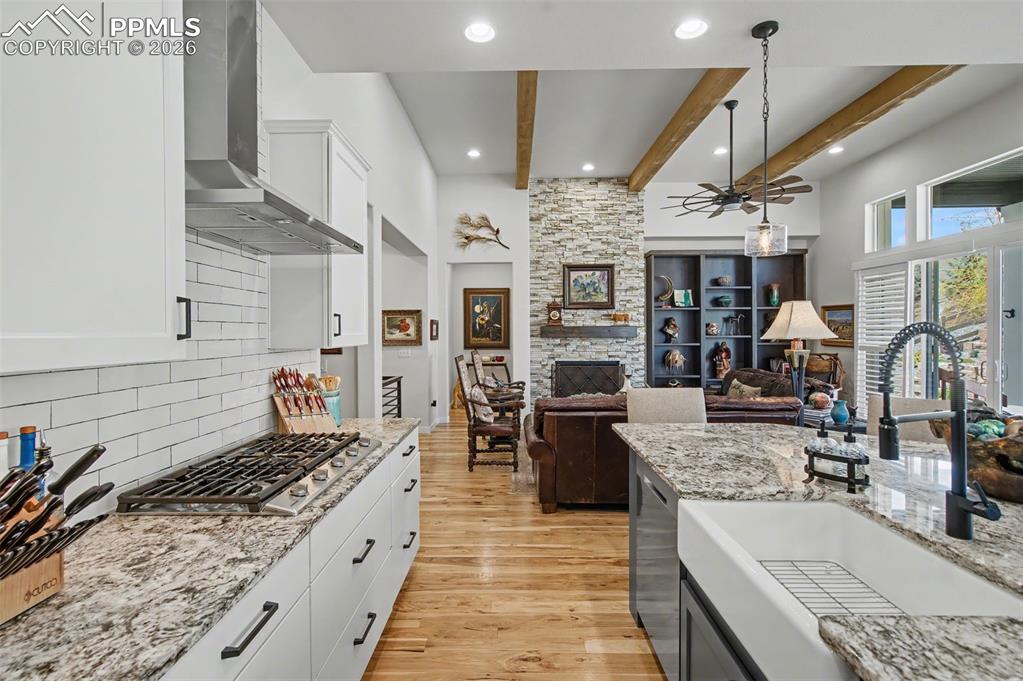 Image 14 of 50: Custom white shaker cabinetry paired with a stylish tile backsplash creates