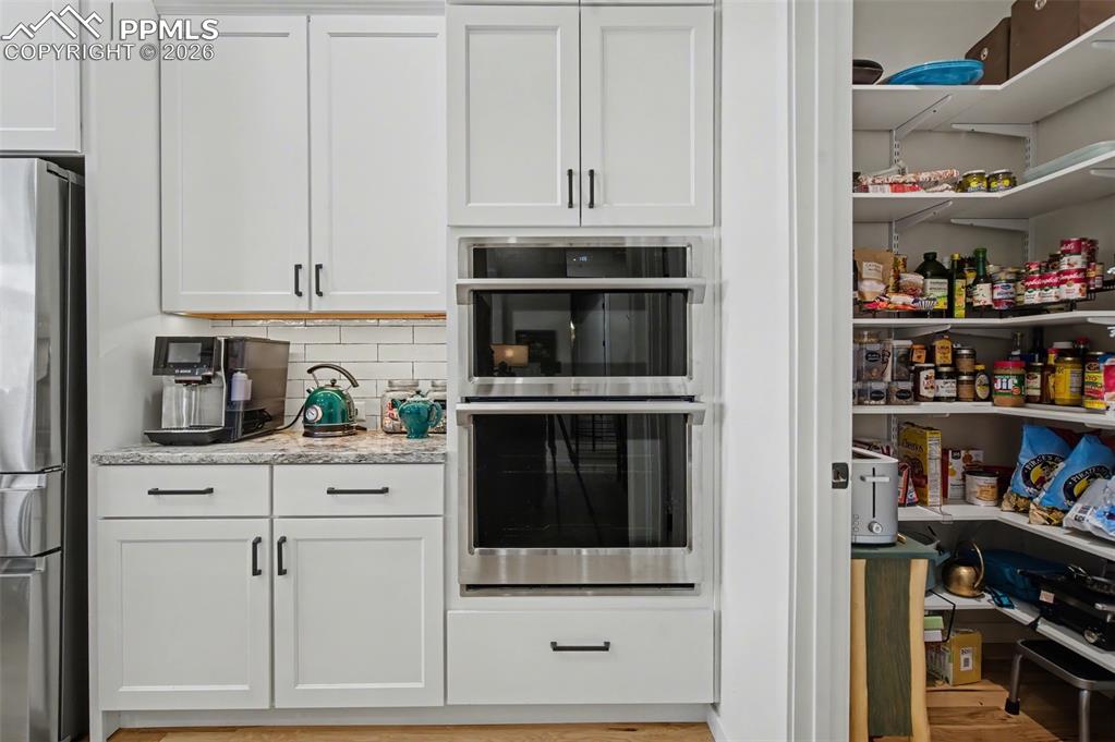 Image 17 of 50: Elevate your dinner parties with premium double ovens and a conveniently lo