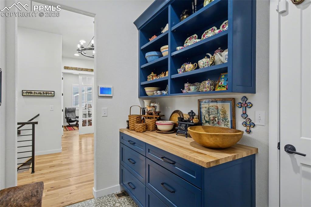 Image 19 of 50: Gorgeous built-in blue cabinetry provides abundant storage and serving spac