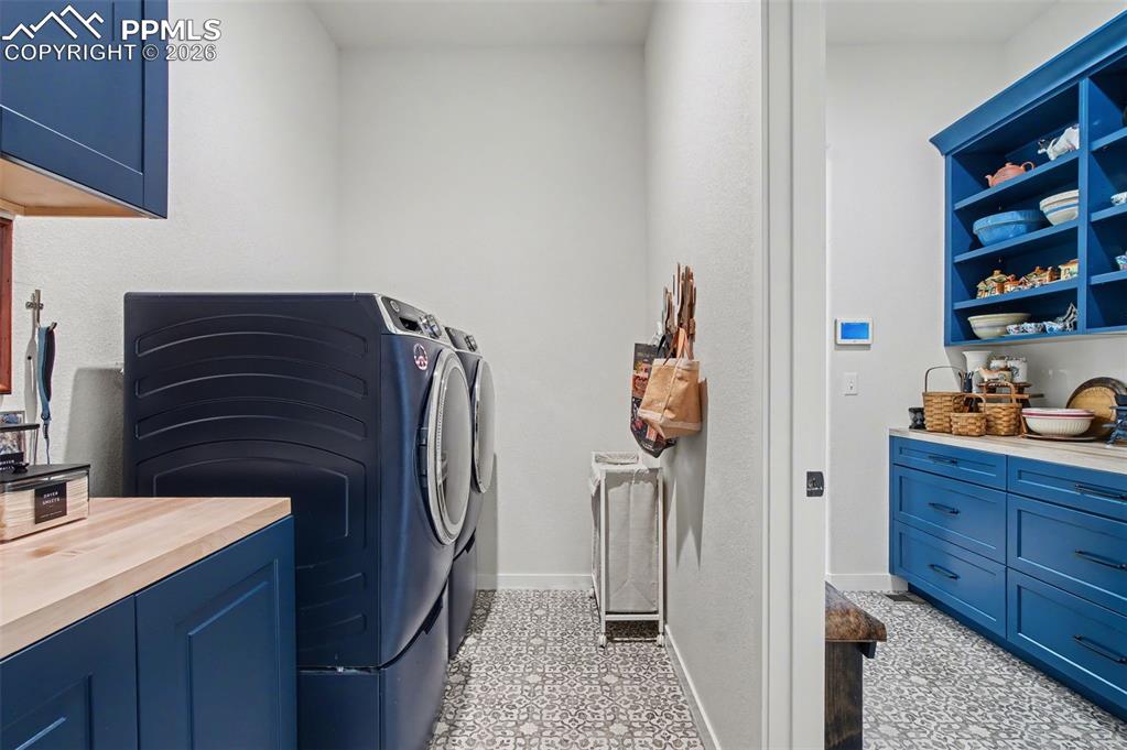 Image 20 of 50: Even everyday chores feel luxurious in this spacious main-level laundry roo