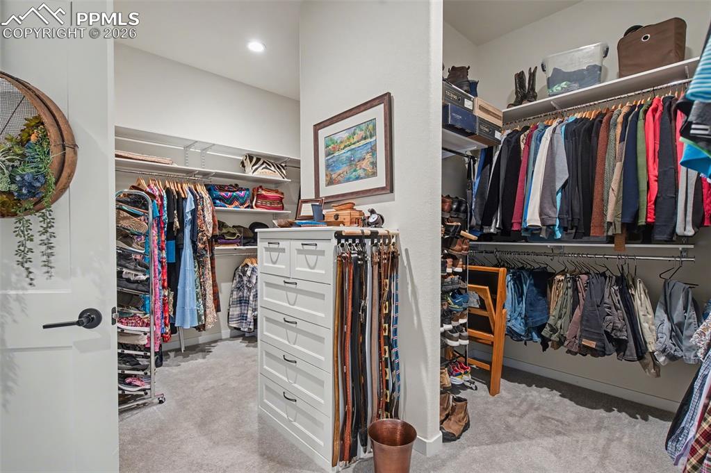 Image 29 of 50: The exceptionally large walk-in closet offers custom built-in shelving to b