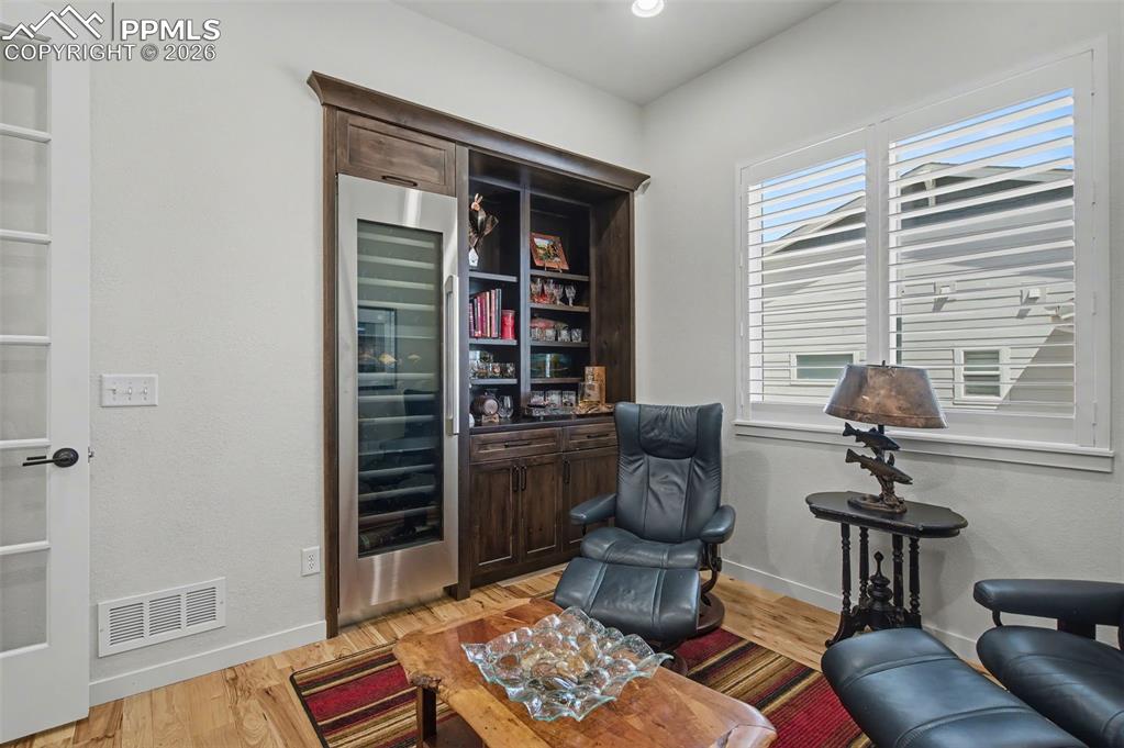 Image 33 of 50: Unwind with a glass of your favorite vintage in this sophisticated sitting 