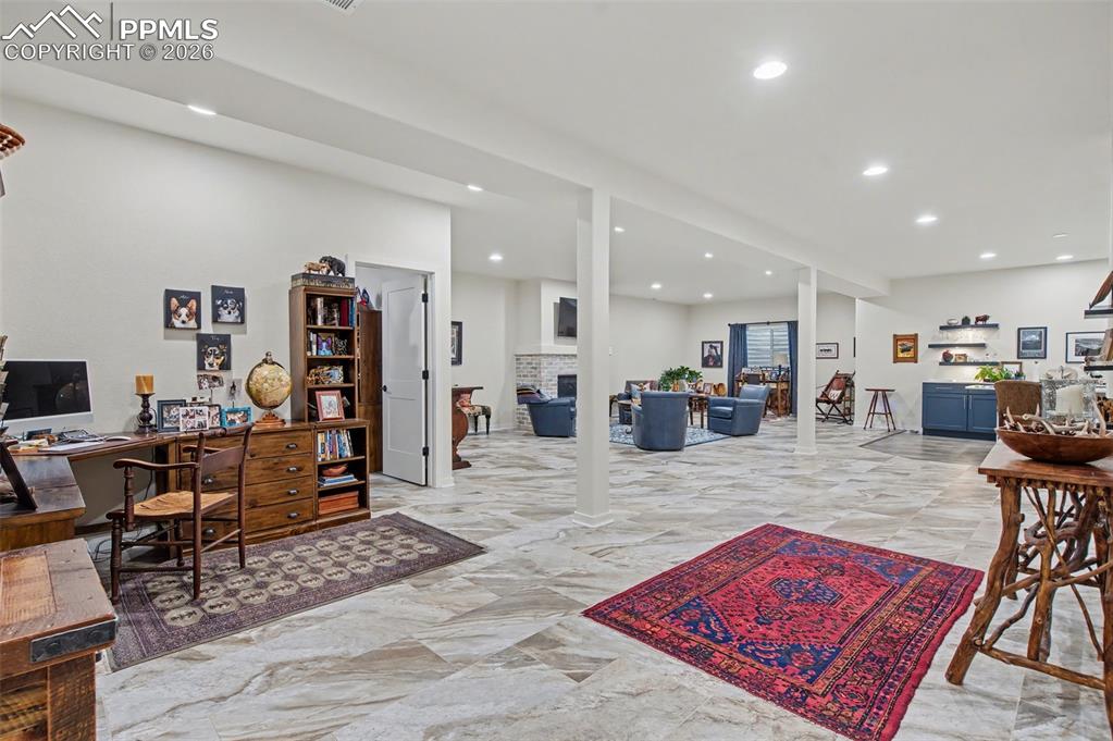 Image 35 of 50: Descend into the expansive finished basement where a massive open-concept f