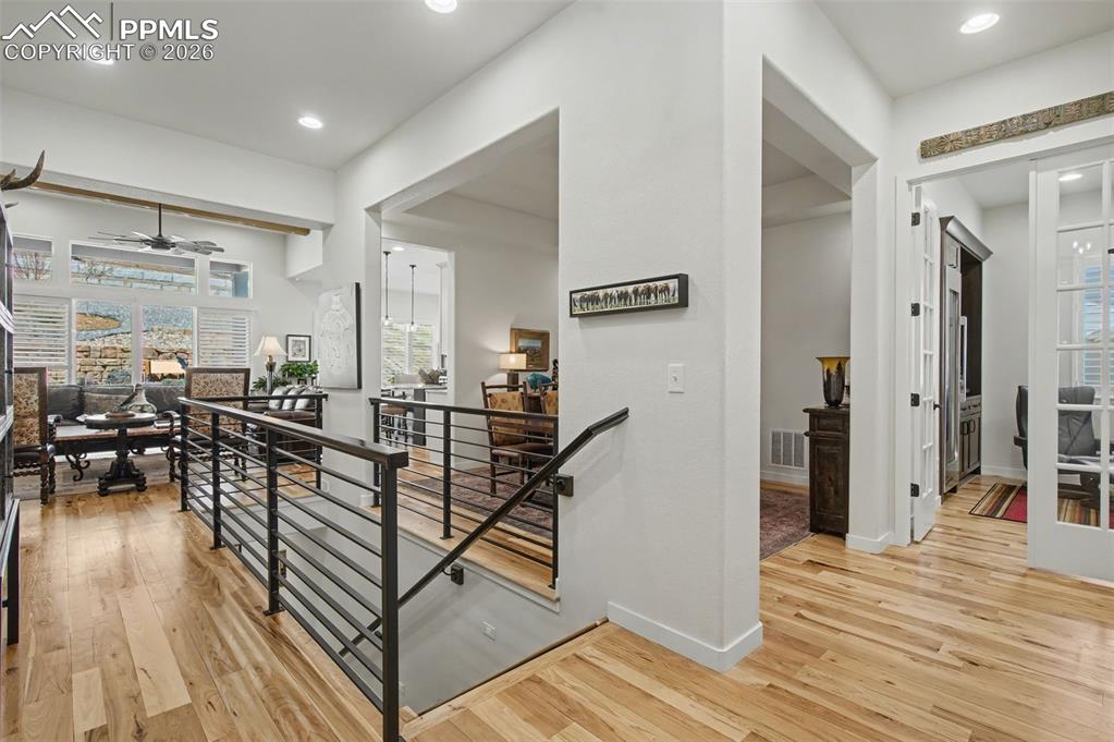 Image 4 of 50: Step through the front door into a bright, open interior where soaring ceil