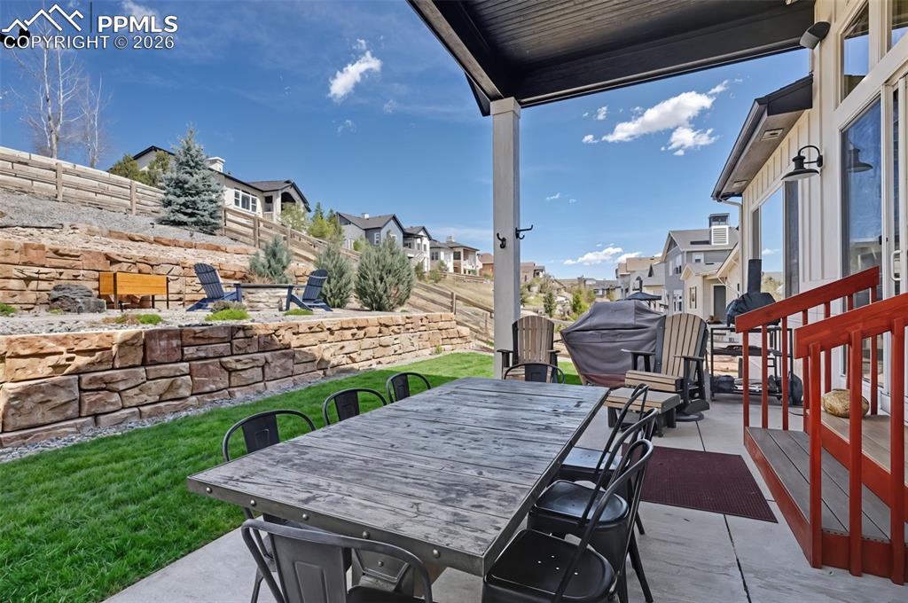 Image 44 of 50: Step outside to the spacious covered concrete patio, an idyllic setting for
