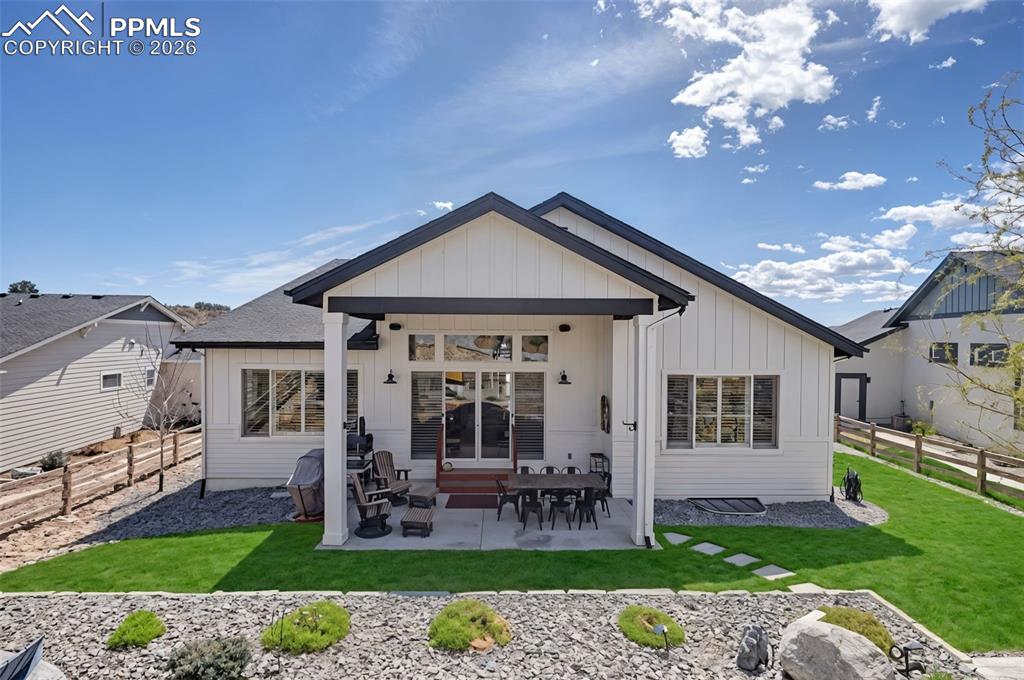 Image 47 of 50: The home’s striking rear elevation perfectly balances modern farmhouse desi