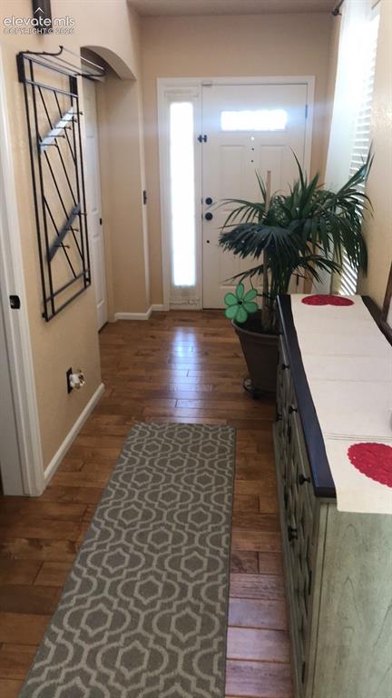 Image 2 of 10: Wood-finish flooring throughout the entry